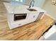 Modern kitchen island with stainless steel appliances, quartz countertops, and sleek white cabinetry at 323 W Claiborne Ct, Marietta, GA 30066
