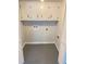 An expansive laundry room has plenty of storage with painted floors and cabinets with dark fixtures at 323 W Claiborne Ct, Marietta, GA 30066