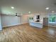 Open concept living space with hardwood floors connecting to a bright kitchen with modern amenities at 323 W Claiborne Ct, Marietta, GA 30066