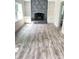 Cozy living room with a stone fireplace, built-in shelving, and wood floors at 323 W Claiborne Ct, Marietta, GA 30066
