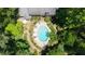 Aerial view of a backyard oasis featuring a large pool surrounded by lush landscaping at 7590 Chaparral Dr, Atlanta, GA 30350