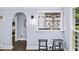 Stylish wet bar area with dark wood floors, bar stools and light blue walls at 7590 Chaparral Dr, Atlanta, GA 30350