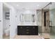 Bright bathroom features double vanity with marble countertops, walk-in shower, and private toilet room at 7590 Chaparral Dr, Atlanta, GA 30350