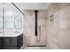 Spa-like bathroom with modern shower system, sleek vanity with double sinks, and neutral tile at 7590 Chaparral Dr, Atlanta, GA 30350