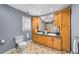 Bright bathroom featuring a double sink vanity with light wood cabinets and a tiled floor at 7590 Chaparral Dr, Atlanta, GA 30350