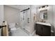 Modern bathroom with a glass-enclosed shower and stylish vanity with marble countertop and dark cabinets at 7590 Chaparral Dr, Atlanta, GA 30350