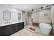 Bright bathroom featuring dual sinks, soaking tub, and modern fixtures at 7590 Chaparral Dr, Atlanta, GA 30350