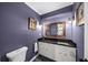 Elegant powder room with custom vanity and stylish framed mirror at 7590 Chaparral Dr, Atlanta, GA 30350