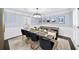 Formal dining room with modern chandelier, seating for ten and detailed trim work at 7590 Chaparral Dr, Atlanta, GA 30350