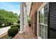 Classic brick home featuring white columns, dark shutters, and a lovely brick walkway at 7590 Chaparral Dr, Atlanta, GA 30350