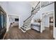 Inviting foyer with dark wood floors and an elegant staircase leading to the second floor at 7590 Chaparral Dr, Atlanta, GA 30350