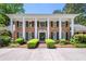 Stately brick home with white columns, black shutters, and manicured landscaping at 7590 Chaparral Dr, Atlanta, GA 30350