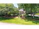Traditional home featuring an expansive, beautifully manicured front lawn and mature trees at 7590 Chaparral Dr, Atlanta, GA 30350