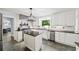 Bright kitchen with black countertops, white cabinets and stainless steel appliances at 7590 Chaparral Dr, Atlanta, GA 30350