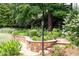 Professionally landscaped garden with stone walls and beautiful flowering plants at 7590 Chaparral Dr, Atlanta, GA 30350