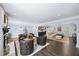 Elegant living room with large windows and a cozy seating arrangement surrounding the fireplace at 7590 Chaparral Dr, Atlanta, GA 30350