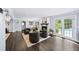 Bright living room with fireplace, modern chairs, dark wood floors and view of the pool at 7590 Chaparral Dr, Atlanta, GA 30350