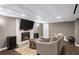 Finished basement with a cozy fireplace, a large TV, and modern flooring at 7590 Chaparral Dr, Atlanta, GA 30350