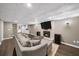 Finished basement with a cozy fireplace, large TV, modern flooring, and a decorative ceiling at 7590 Chaparral Dr, Atlanta, GA 30350