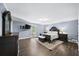 Spacious main bedroom suite featuring dark wood floors and stylish furniture at 7590 Chaparral Dr, Atlanta, GA 30350