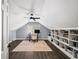 Bright home office with sloped ceilings, built-in shelving, modern desk and chair, and natural light at 7590 Chaparral Dr, Atlanta, GA 30350