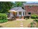 Covered patio and outdoor dining area surrounded by lush landscaping at 7590 Chaparral Dr, Atlanta, GA 30350
