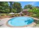 Relaxing outdoor pool area with lounge chairs and umbrellas, perfect for entertaining at 7590 Chaparral Dr, Atlanta, GA 30350