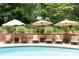 Outdoor poolside lounge area with umbrellas and comfortable seating at 7590 Chaparral Dr, Atlanta, GA 30350