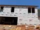 View of home construction with ProLinx building wrap, rough cut window framing and OSB roof decking at 95 Cambridge Dr, Covington, GA 30014