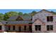 Close up shot of a two story home under construction with a black roof and wrapped in ProLinx building wrap at 95 Cambridge Dr, Covington, GA 30014