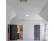 Brightly lit finished attic with white walls and two doors, one leading to the bathroom at 136 Beutell St, Norcross, GA 30071