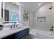Modern bathroom with marble countertops, a black faucet, and a luxurious shower and bathtub at 136 Beutell St, Norcross, GA 30071