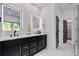 Stylish bathroom with dual sinks, illuminated mirrors, walk-in closet, and a glass shower at 136 Beutell St, Norcross, GA 30071