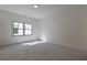 Serene bedroom with a large window bringing in natural light, highlighting the neutral decor at 136 Beutell St, Norcross, GA 30071