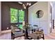 Elegant dining room with modern light fixture, gray accent wall, and a large window that adds to the ambiance at 136 Beutell St, Norcross, GA 30071