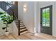 Inviting entryway with modern staircase, stylish light fixtures, and a gray door that creates a lasting first impression at 136 Beutell St, Norcross, GA 30071