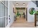 Bright foyer with hardwood floors, modern lighting, and a view into the kitchen that invites exploration at 136 Beutell St, Norcross, GA 30071