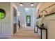 Elegant foyer with hardwood floors, modern decor, and a view to the door with a stylish mirror on the wall at 136 Beutell St, Norcross, GA 30071