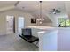 Upstairs hallway with a view to a bathroom; decorated with a stylish bench and modern light fixture at 136 Beutell St, Norcross, GA 30071
