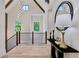 Hallway featuring modern railings, wood flooring, high ceilings, elegant lighting, and natural light at 136 Beutell St, Norcross, GA 30071