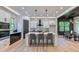 Gourmet kitchen with white cabinets, an island with seating, and stainless steel appliances open to the dining room at 136 Beutell St, Norcross, GA 30071
