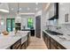 Open concept kitchen with quartz counters, modern black and white cabinetry, and stainless steel appliances at 136 Beutell St, Norcross, GA 30071