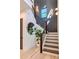 Staircase featuring modern railings, dark accent wall, beautiful wall lighting, and a decorative mirror at 136 Beutell St, Norcross, GA 30071