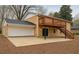 Backyard of brick house with a deck, patio, and garage at 1607 Hillview, Jonesboro, GA 30236
