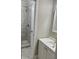 Bathroom with shower, gray tile, white vanity, and modern faucet at 1607 Hillview, Jonesboro, GA 30236