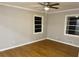 Neutral bedroom with hardwood floors, crown molding, ceiling fan, and two windows at 1607 Hillview, Jonesboro, GA 30236