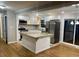 Bright, modern kitchen features stainless steel appliances, granite countertops, and an eat-in island at 1607 Hillview, Jonesboro, GA 30236
