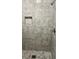 Close-up of shower with gray tile and a built-in shelf at 1607 Hillview, Jonesboro, GA 30236