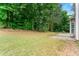 A large backyard with mature trees and a patio area, creating a private and serene outdoor space at 2994 Meadow Church Rd, Suwanee, GA 30024