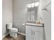 Well-lit half bathroom with modern fixtures, vanity, and toilet at 2994 Meadow Church Rd, Suwanee, GA 30024